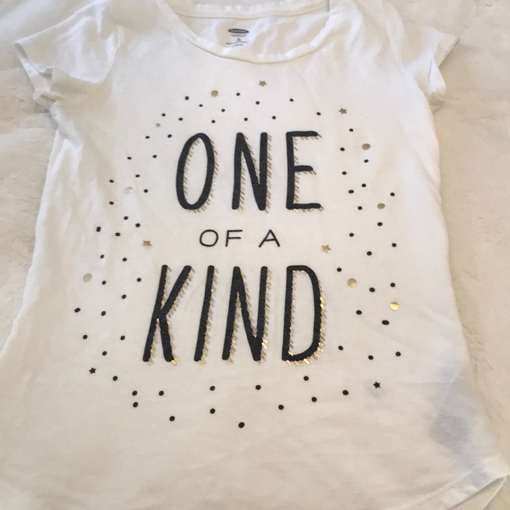 White shirt with black and gold words and dots